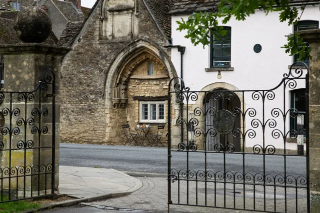 Historic arch and frontage of 1 Almshouses in Malmesbury