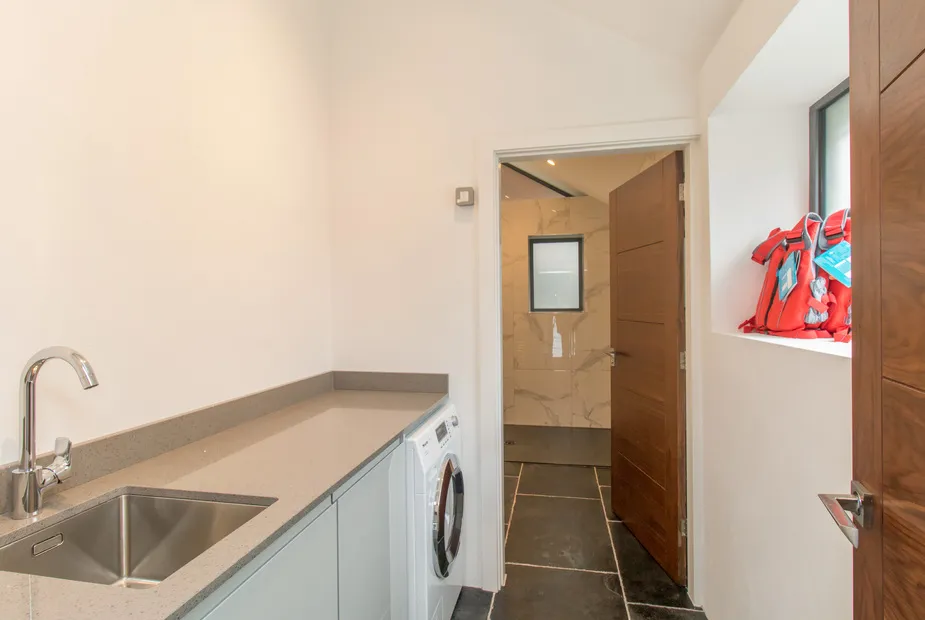 Utility room with sink and laundry appliances