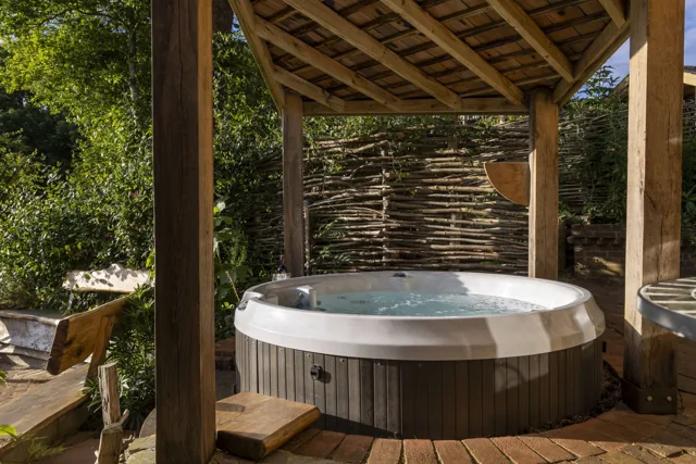 Chestnut’s private hot tub beneath a timber shelter