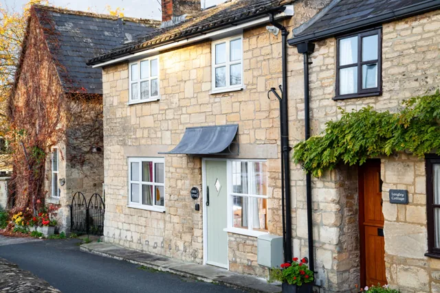 Honey-coloured stone front of Forge Cottage in Winchcombe
